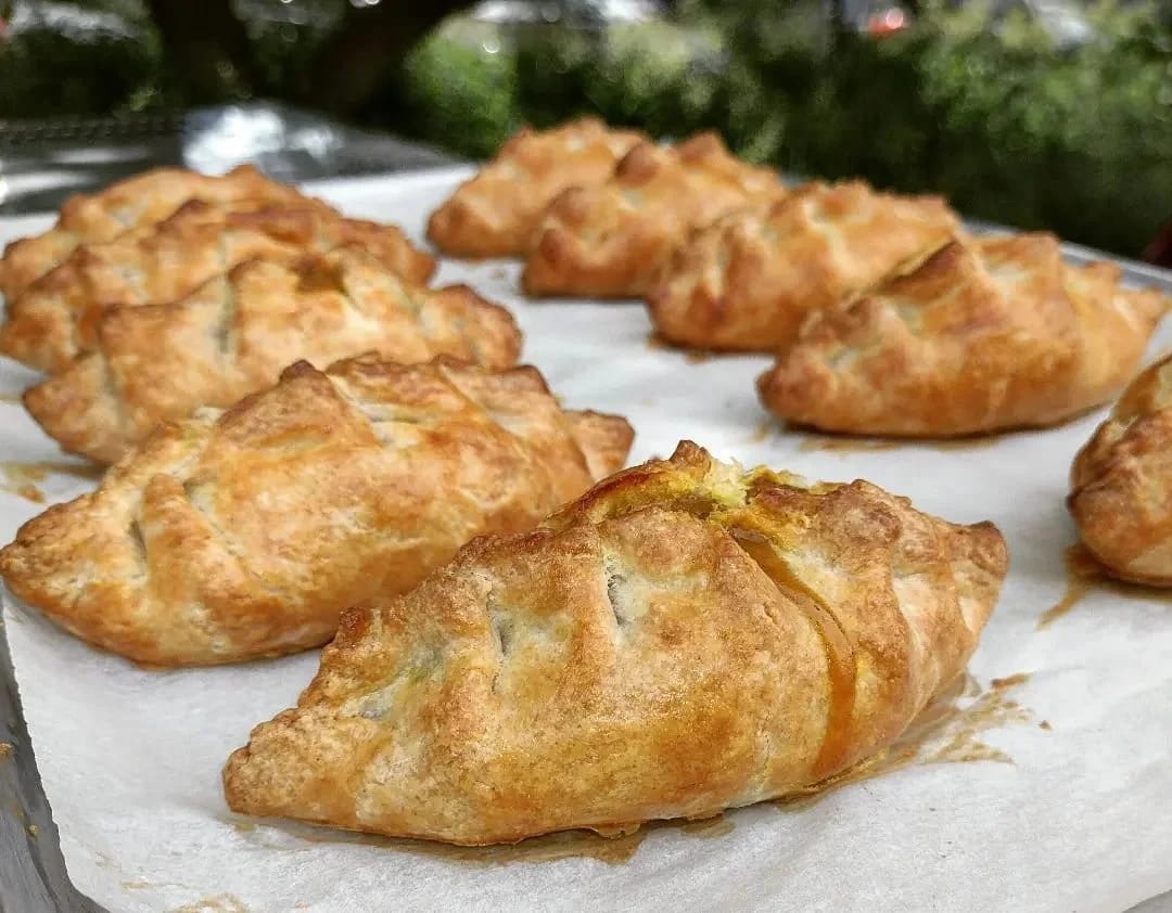 A tray of savory hand pies fresh out of the oven